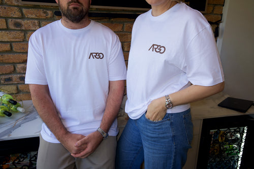 Two people wearing white Argo Co Working logo t-shirts at the Albion Brisbane coworking space